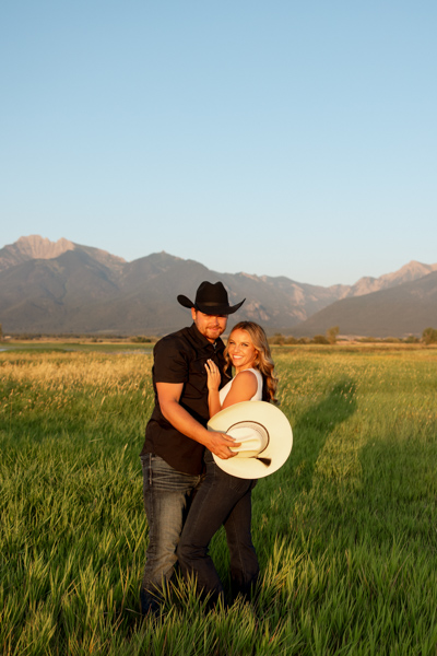 Rilee and Colby smiling and looking at the camera in a wide shot during their Mission Valley engagement session