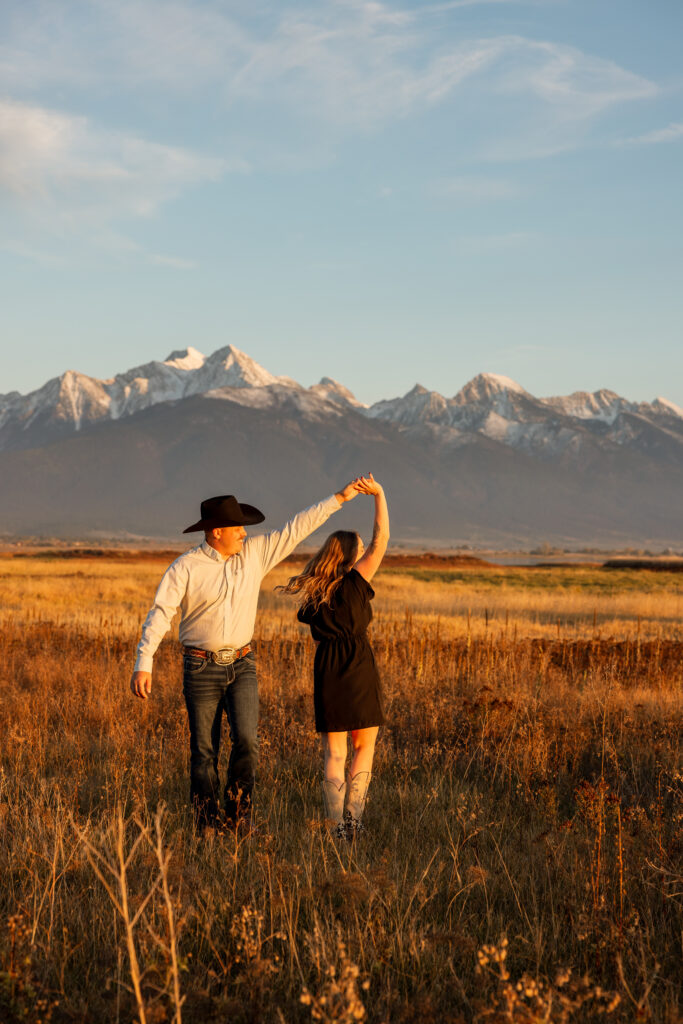 couple dancing during an engagement session with mission mountain views