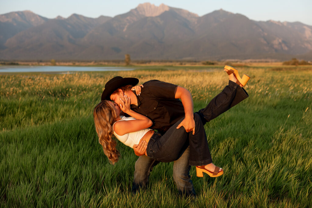 a dip kiss in front of the mission mountains