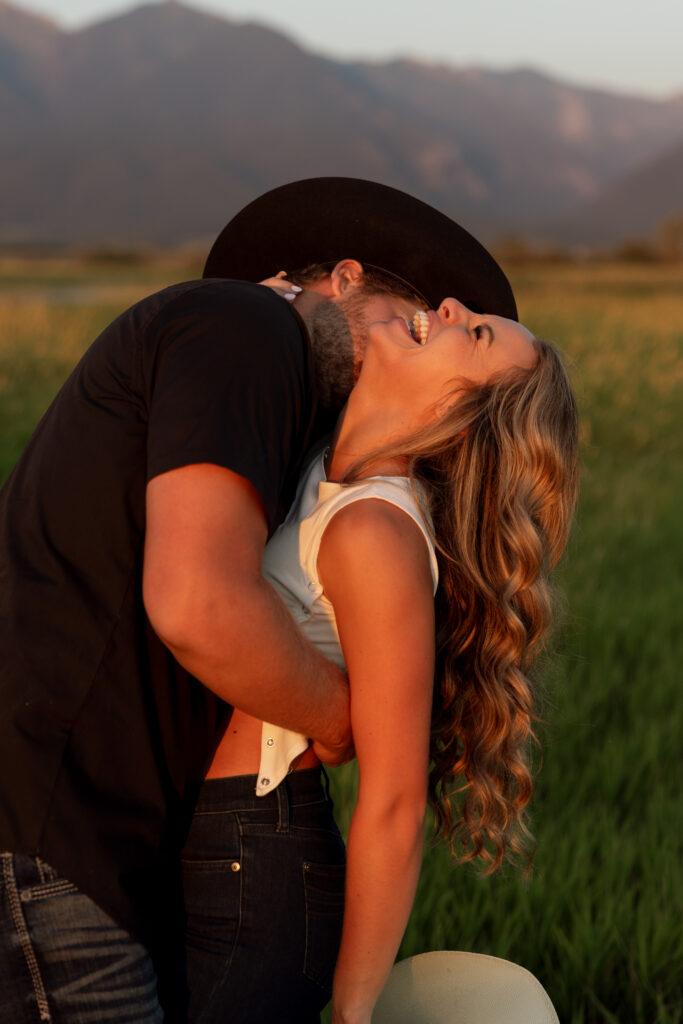 couple laughing during a mission valley engagement session in charlo montana