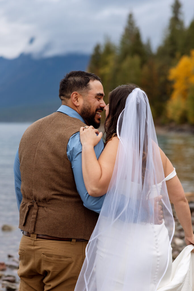 bride and groom smiling and laughing during glacier national park elopement