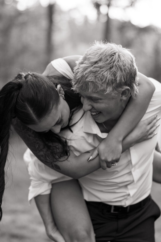 bride getting a piggy back ride from groom