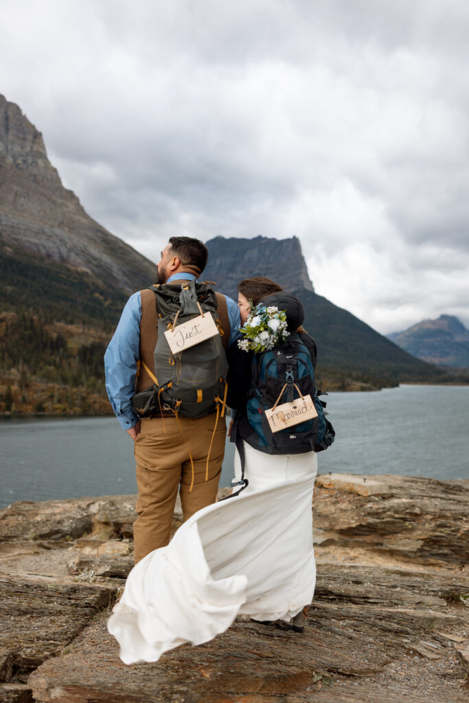 fun hiking photo of bride and groom during glacier national park elopement