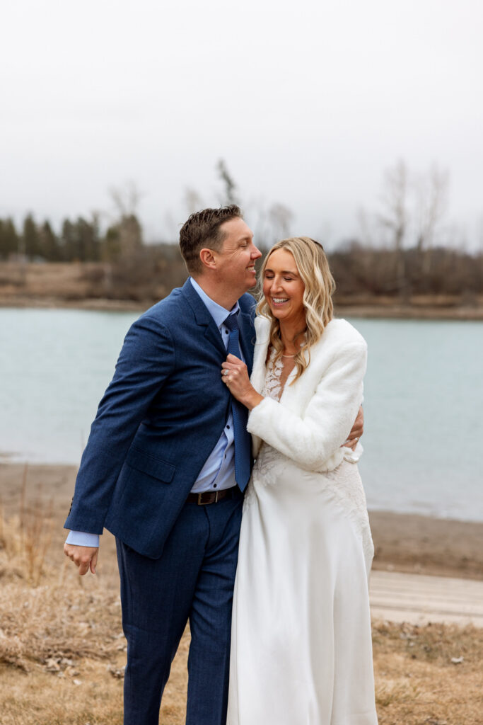Groom kissing bride on the forehead while she laughs softly at Diamond B Weddings — Kalispell Montana wedding photographer — Stacy Edwards Photography
