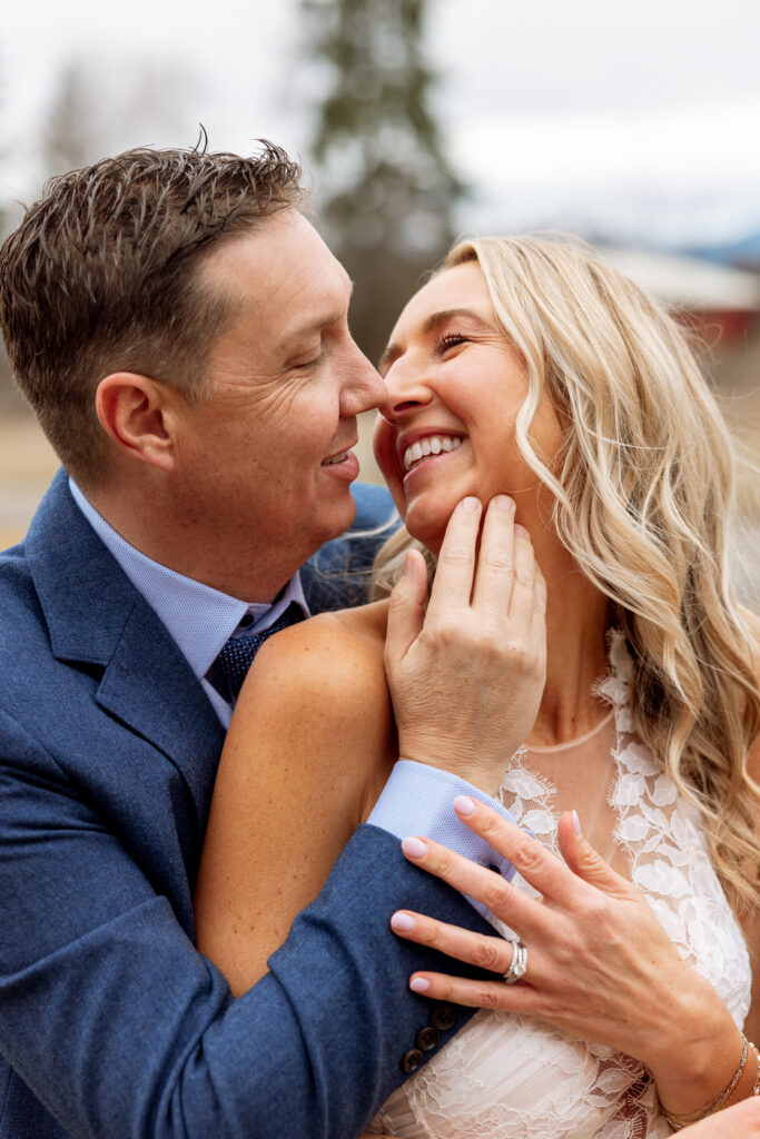 Groom hugging bride from behind smiling and laughing together at Diamond B Weddings — Kalispell Montana wedding photographer — Stacy Edwards Photography