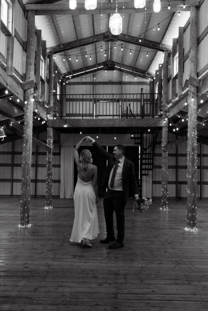 Black and white of groom twirling bride at Diamond B Weddings — Kalispell Montana wedding photographer — Stacy Edwards Photography
