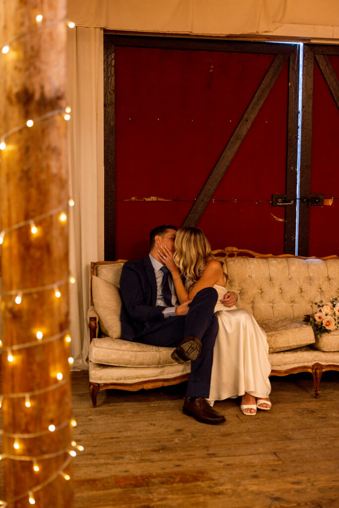 Bride and groom kissing on decorative couch at Diamond B Weddings — Kalispell Montana wedding photographer — Stacy Edwards Photography