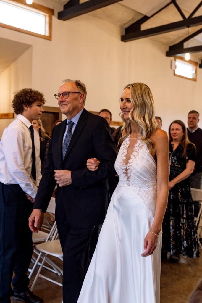 Bride and father walking down the aisle smiling at groom at Diamond B Weddings — Kalispell Montana wedding photographer — Stacy Edwards Photography