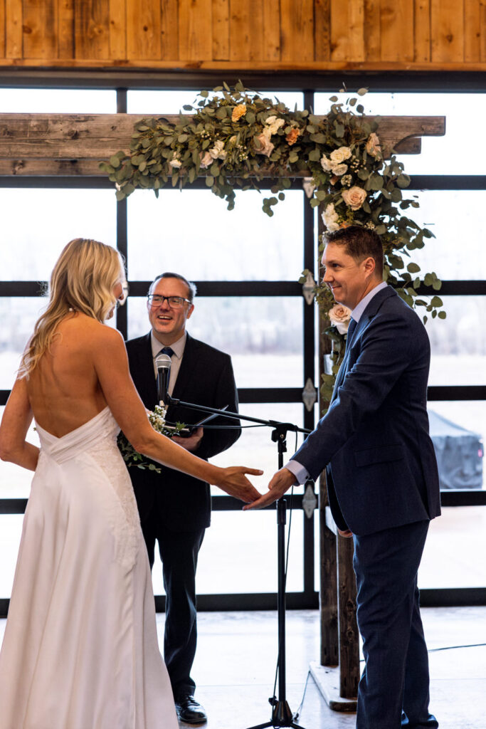 Groom taking bride's hand at the altar at Diamond B Weddings — Kalispell Montana wedding photographer — Stacy Edwards Photography