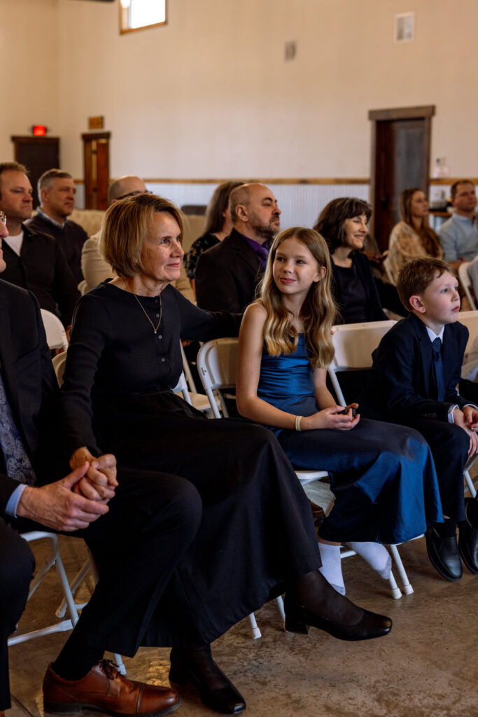 Groom's daughter smiling at bride's mom during wedding ceremony at Diamond B Weddings — Kalispell Montana wedding photographer — Stacy Edwards Photography