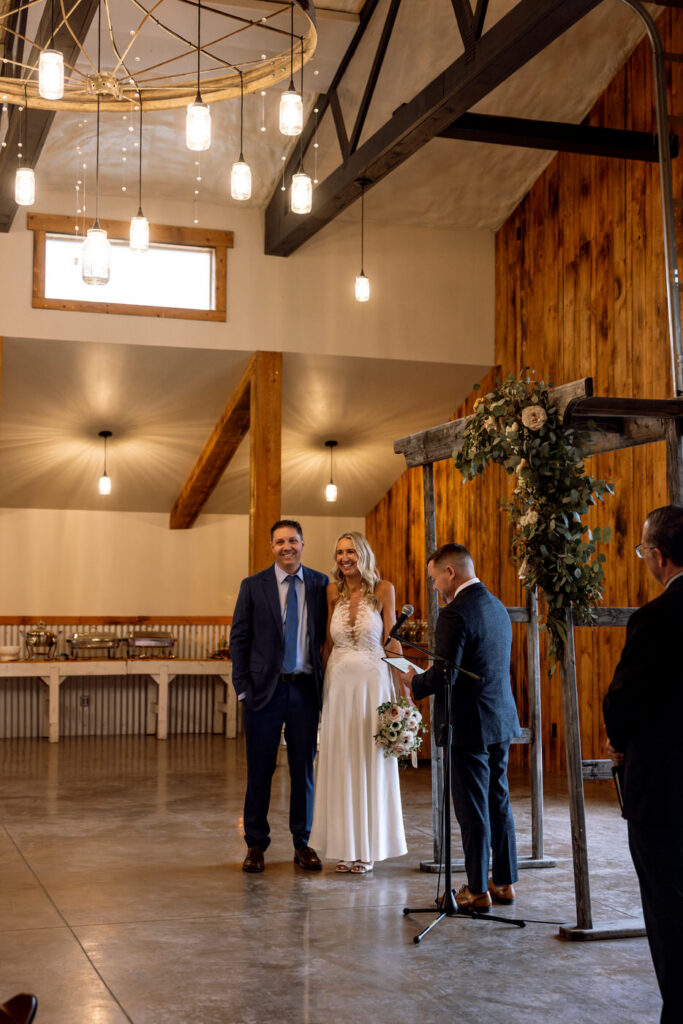 Bride and groom softly laughing together at the altar during ceremony at Diamond B Weddings — Kalispell Montana wedding photographer — Stacy Edwards Photography