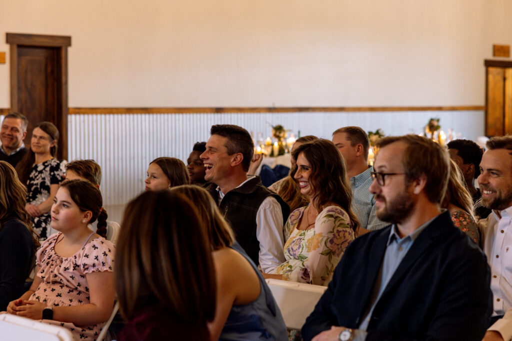 Wedding guests smiling and laughing during ceremony at Diamond B Weddings — Kalispell Montana wedding photographer — Stacy Edwards Photography