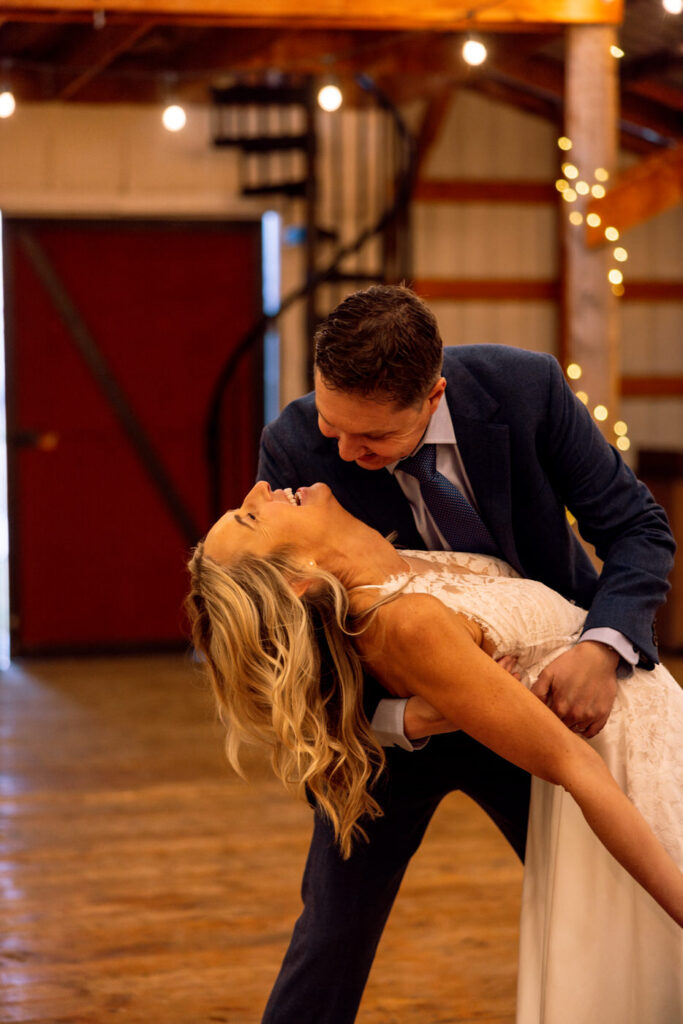 Groom dipping bride while she laughs at Diamond B Weddings — Kalispell Montana wedding photographer — Stacy Edwards Photography