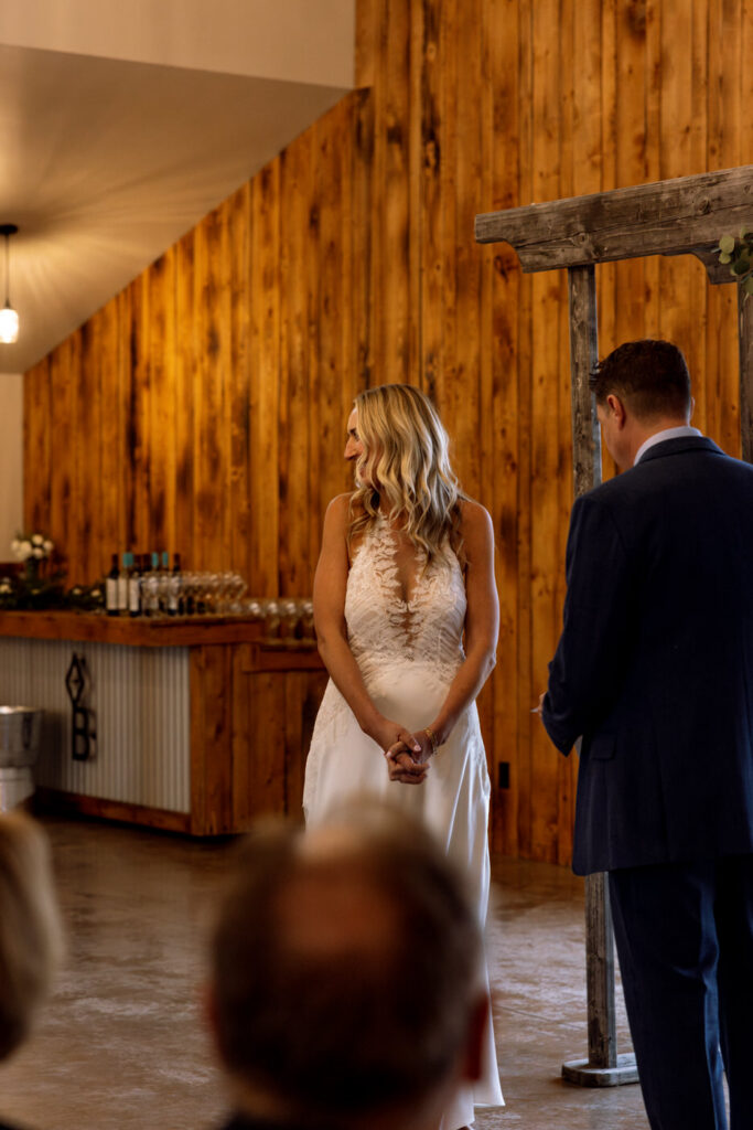 Bride smiling at wedding guests while standing at the altar at Diamond B Weddings — Kalispell Montana wedding photographer — Stacy Edwards Photography