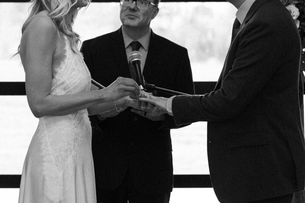 Black and white close up of bride placing wedding ring on groom's finger at Diamond B Weddings — Kalispell Montana wedding photographer — Stacy Edwards Photography
