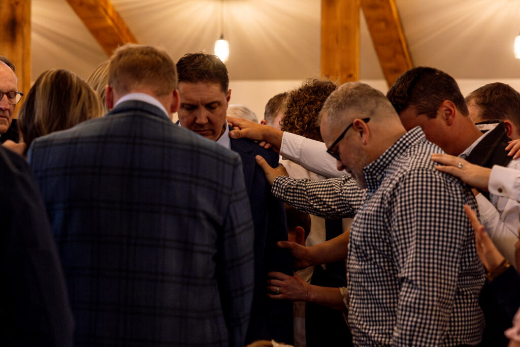 Emotional prayer circle moment during intimate wedding ceremony — Scott and Molly — Diamond B Weddings Kalispell Montana — Stacy Edwards Photography