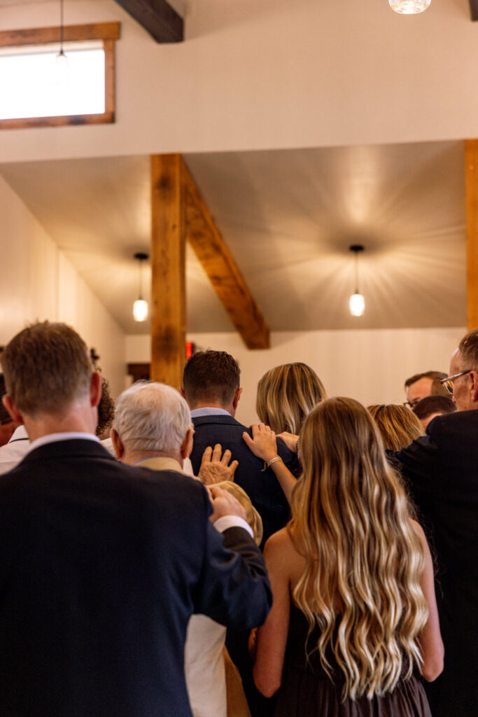 Wide shot of prayer circle surrounding bride and groom during wedding ceremony — Scott and Molly — Diamond B Weddings Kalispell Montana — Stacy Edwards Photography