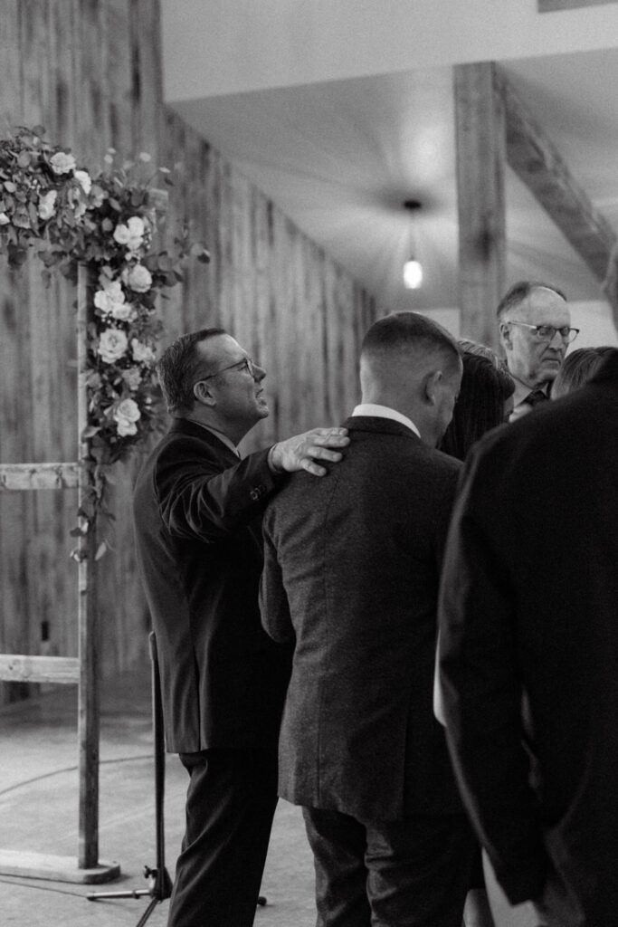 Wedding guests surrounding bride and groom in prayer circle during ceremony — Scott and Molly — Diamond B Weddings Kalispell Montana — Stacy Edwards Photography