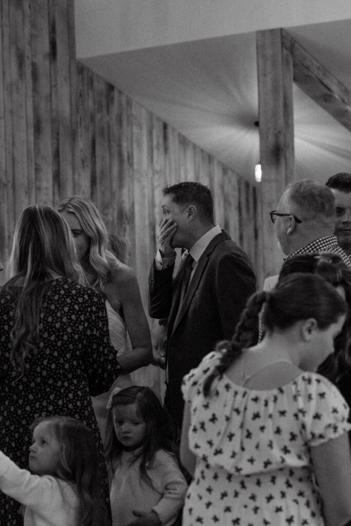 Emotional groom crying during prayer circle moment with wedding guests — Scott and Molly — Diamond B Weddings Kalispell Montana — Stacy Edwards Photography