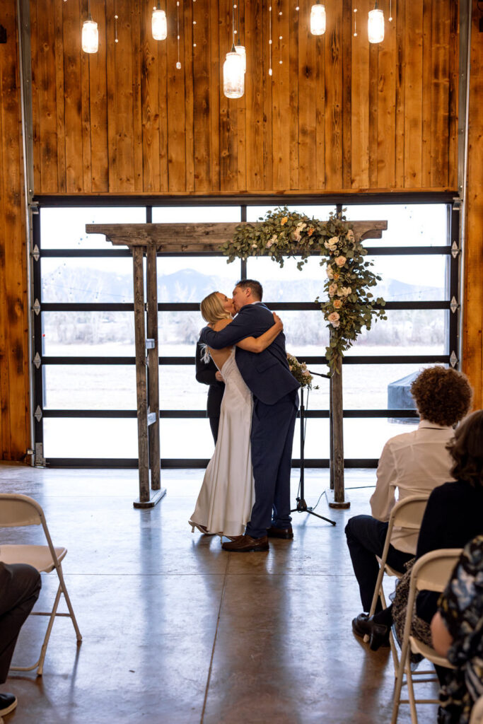 Bride and groom first kiss at the altar — Scott and Molly — Diamond B Weddings Kalispell Montana — Stacy Edwards Photography