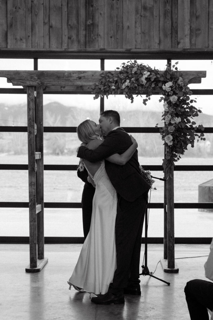 Black and white first kiss at the altar — Scott and Molly — Diamond B Weddings Kalispell Montana — Stacy Edwards Photography