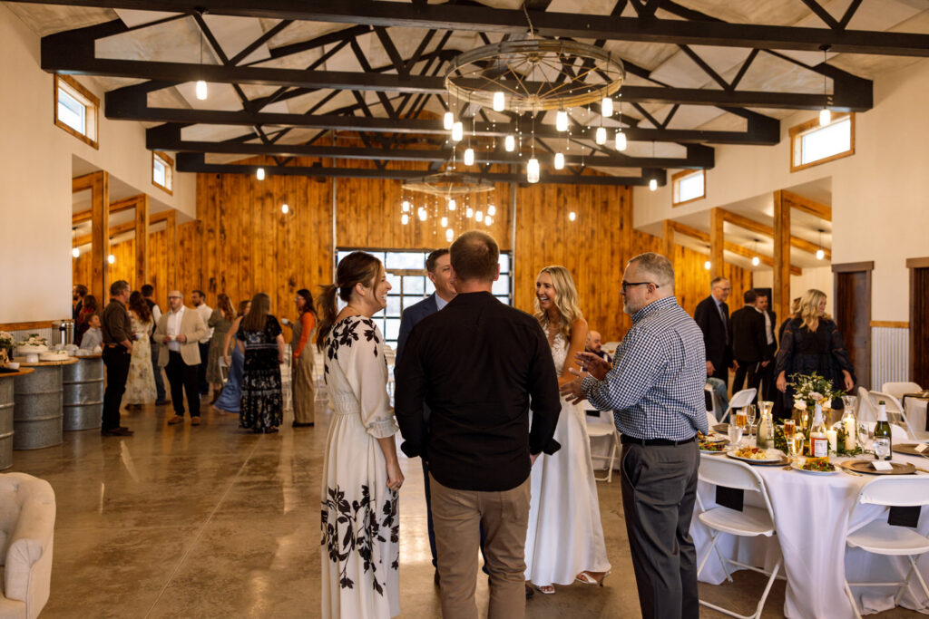 Bride and groom laughing with wedding guests during reception — Scott and Molly — Diamond B Weddings Kalispell Montana — Stacy Edwards Photography