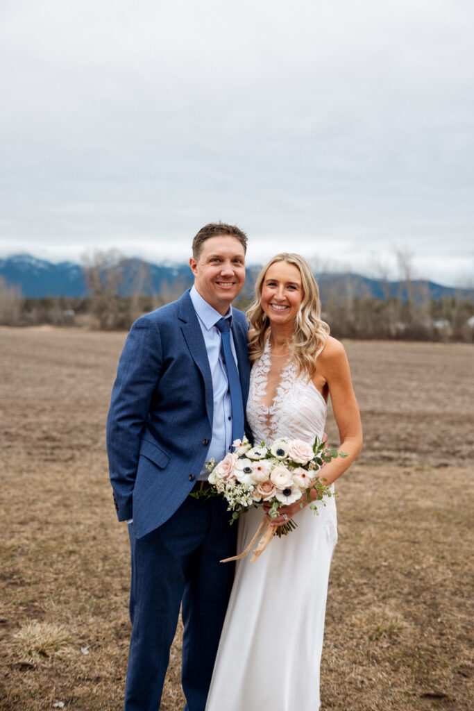 Bride and groom outdoor couples portrait smiling at camera — Scott and Molly — Diamond B Weddings Kalispell Montana — Stacy Edwards Photography