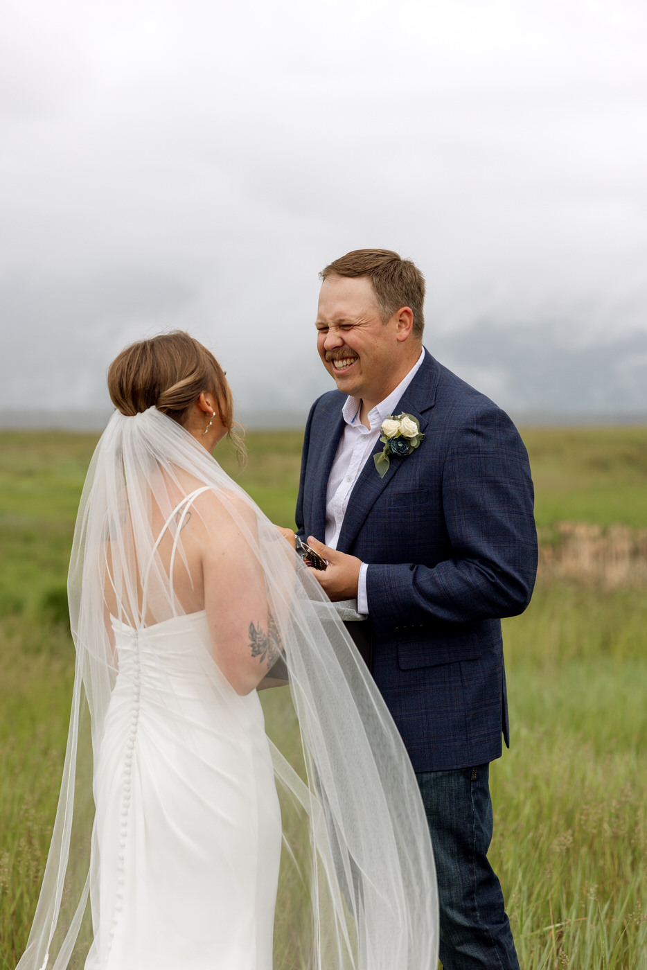 Groom smiling at bride after receiving her wedding gift — Aislynn + Kyle — Mission Valley Wedding — Charlo Montana — Stacy Edwards Photography