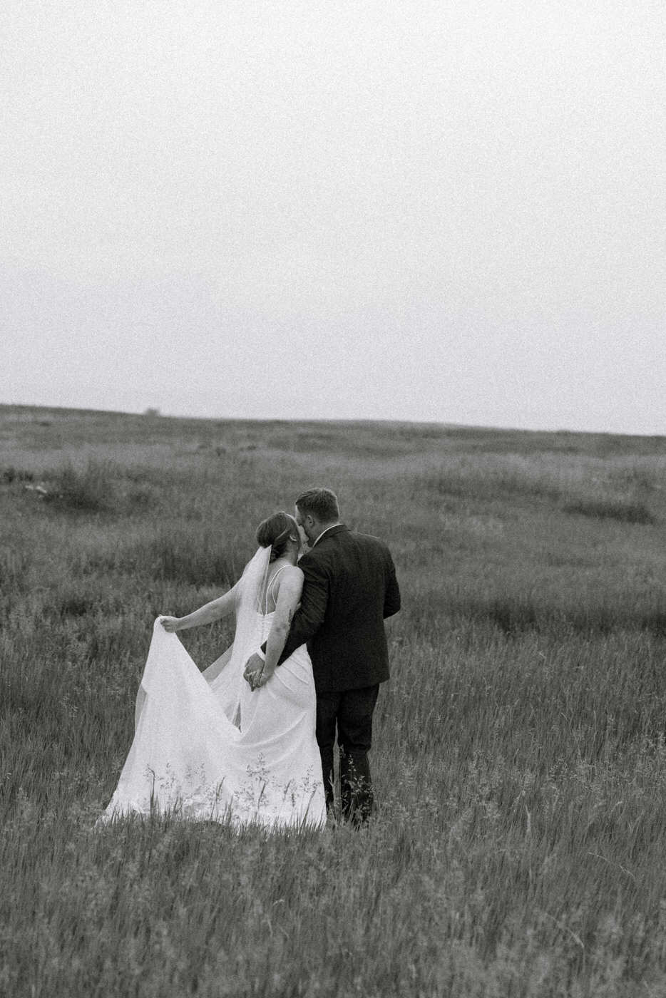 Black and white photo of bride and groom sharing a romantic moment — Aislynn + Kyle — Mission Valley Wedding — Charlo Montana — Stacy Edwards Photography