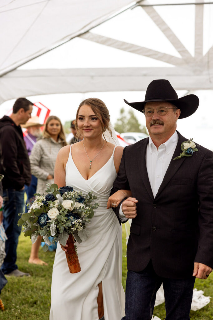father of the bride walking the bride down the aisle at the ceremony — Aislynn + Kyle — Mission Valley Wedding — Charlo Montana — Stacy Edwards Photography