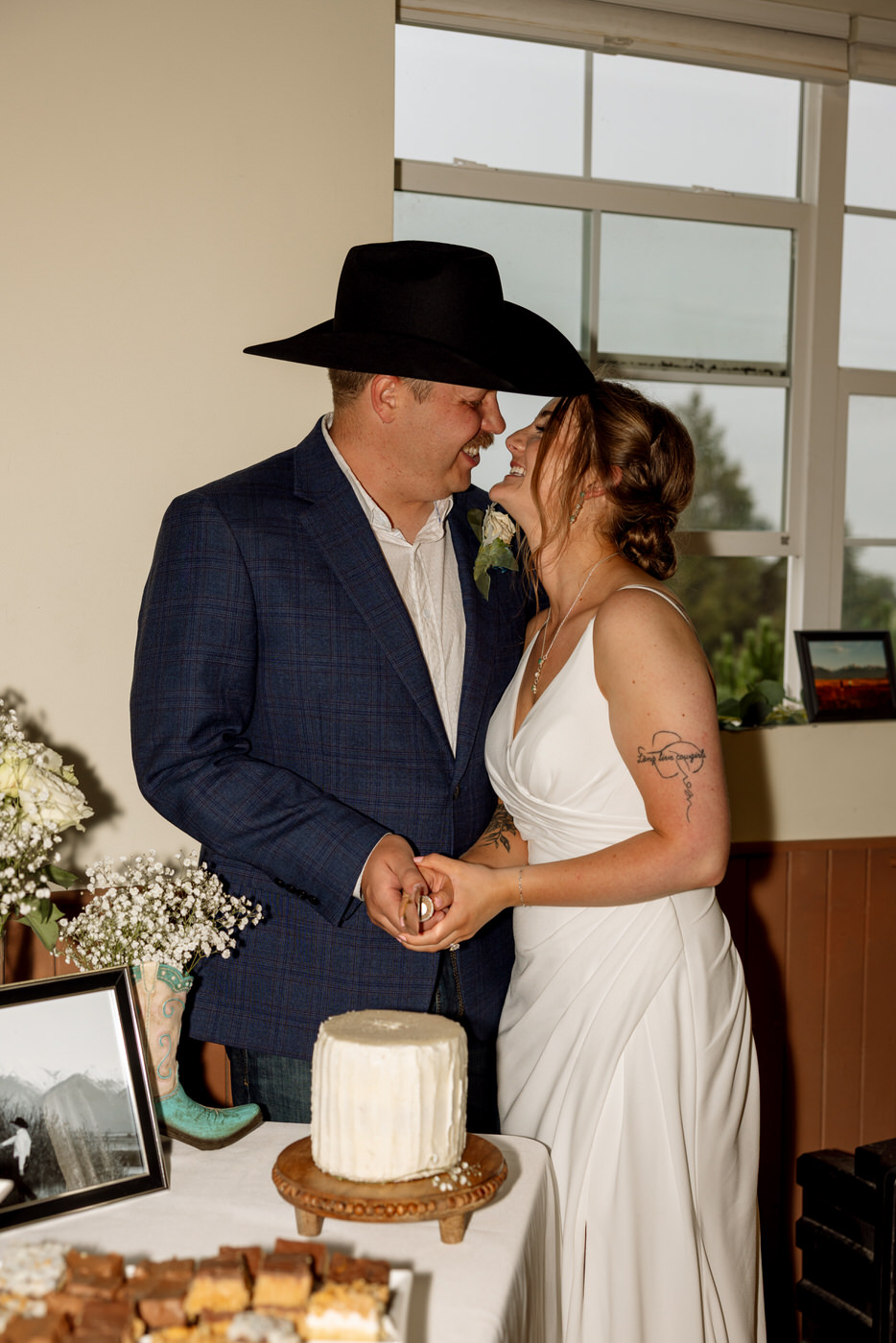 Bride and groom getting ready to cut the wedding cake — Aislynn + Kyle — Mission Valley Wedding — Charlo Montana — Stacy Edwards Photography