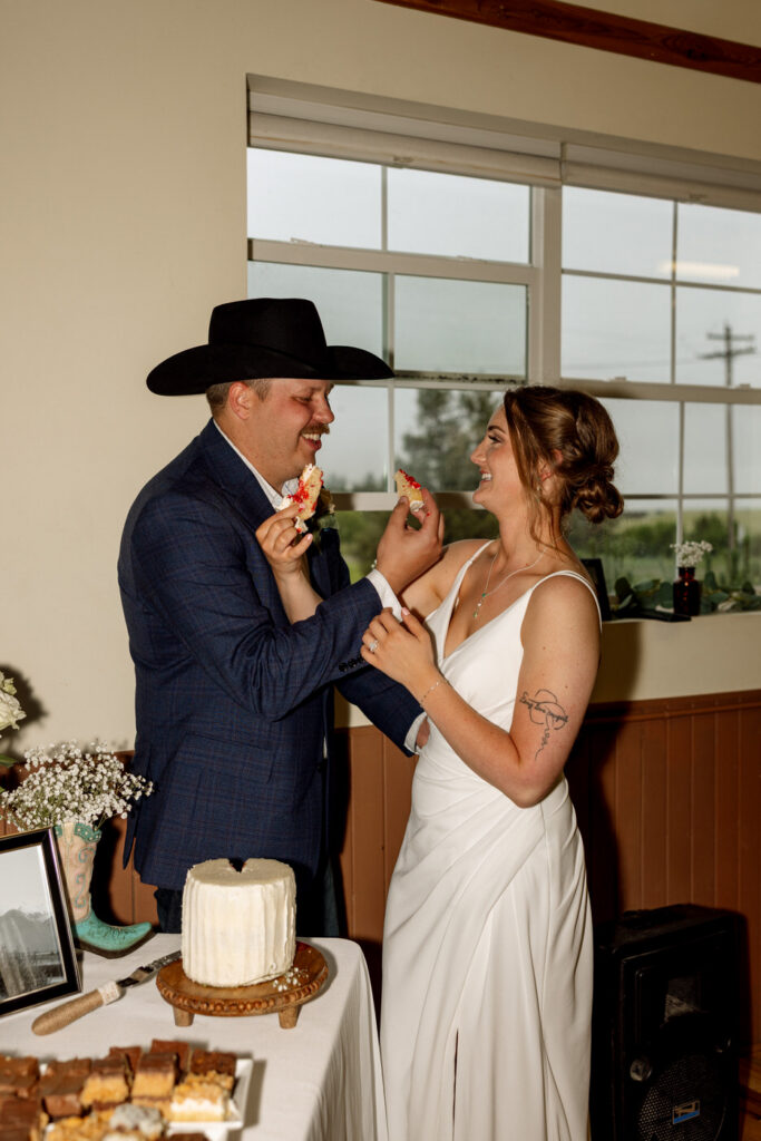 Bride and groom moments before taking a bite of the wedding cake — Aislynn + Kyle — Mission Valley Wedding — Charlo Montana — Stacy Edwards Photography
