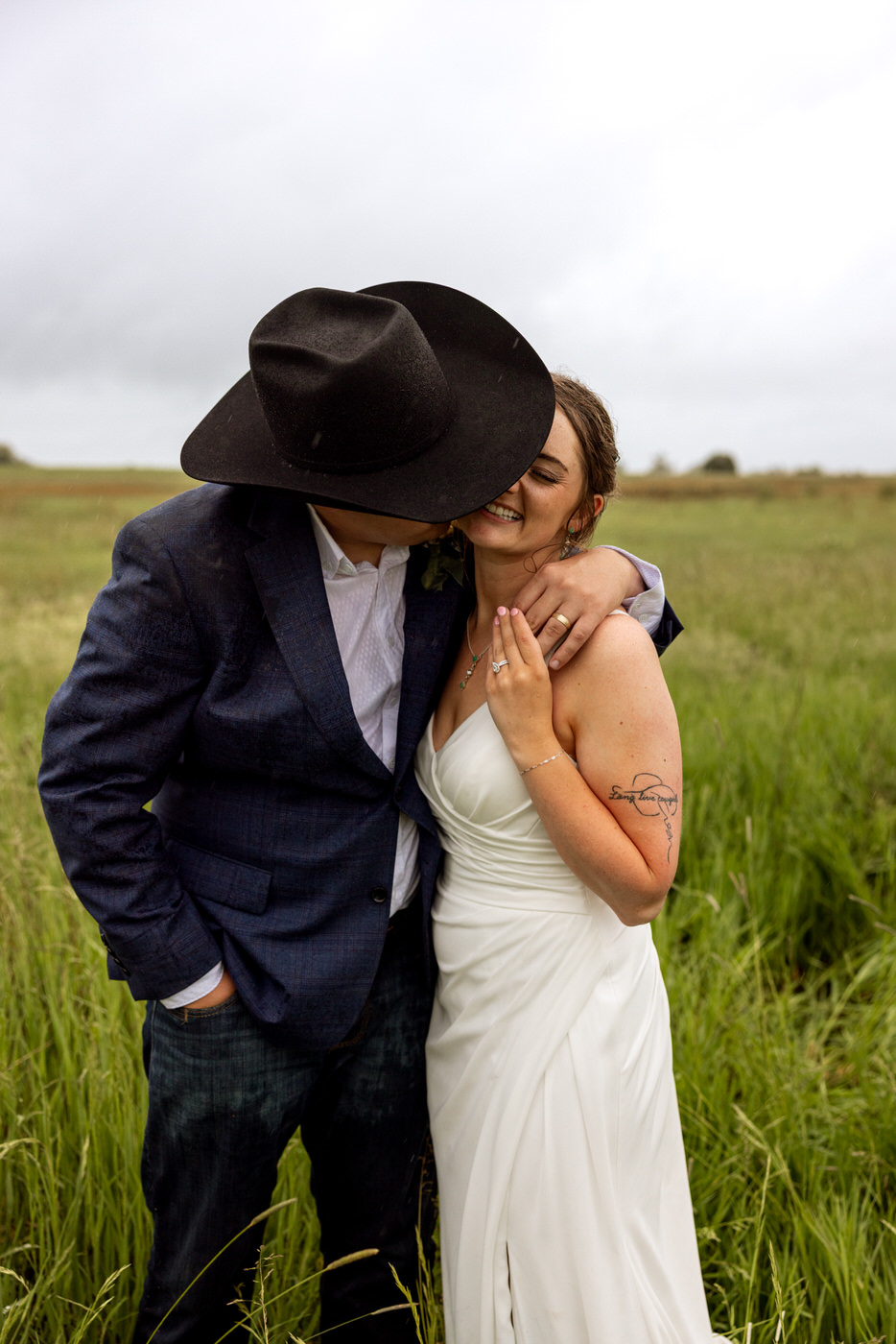 Groom kissing bride on the cheek, bride smiling — Aislynn + Kyle — Mission Valley Wedding — Charlo Montana — Stacy Edwards Photography
