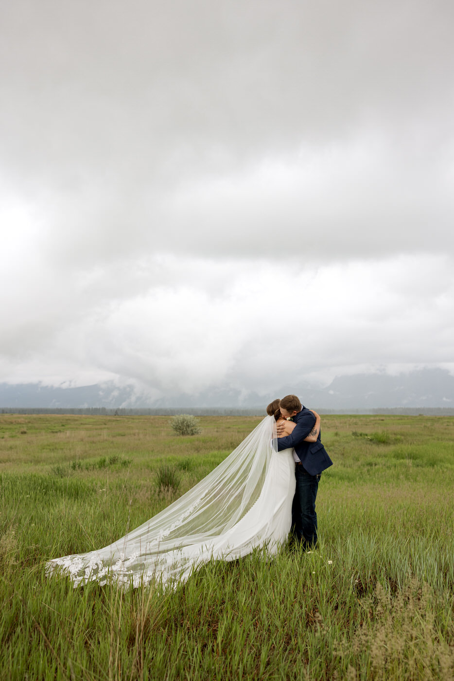 Wide Shot Photo of Bride and Groom Hugging — Aislynn + Kyle — Mission Valley Wedding — Charlo Montana — Stacy Edwards Photography