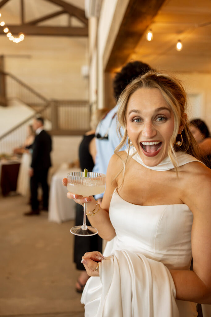 Bride laughing and holding cocktail during wedding reception at Ember and Altar — wedding day coverage — Montana wedding photographer Stacy Edwards Photography
