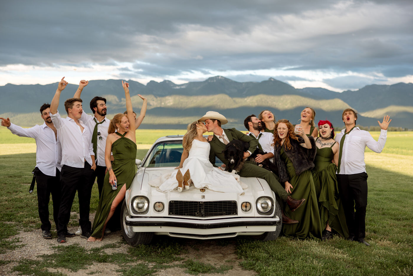 Wedding party group photo on classic Camaro with Mission Valley mountains in the background at Ember and Altar — Montana wedding photographer Stacy Edwards Photography