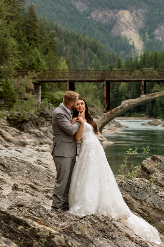Bride leaning into bride in sweet moment at Belton Bridge | Stacy Edwards Photography