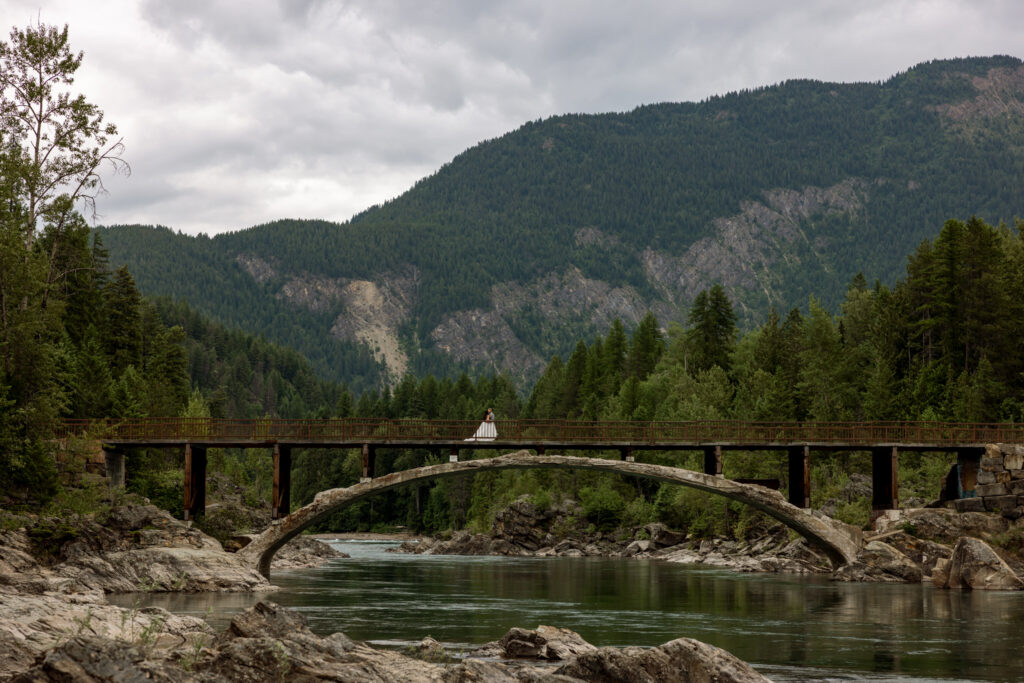Bride and groom crossing Belton Bridge | Glacier National Park | Stacy Edwards Photography