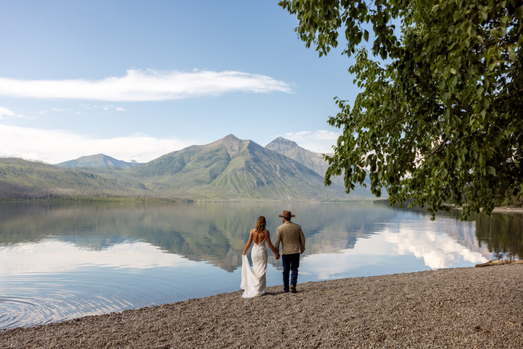 Bride and groom look out over the water at the mountain views at Jackson Bay | Glacier National Park | Stacy Edwards Photography