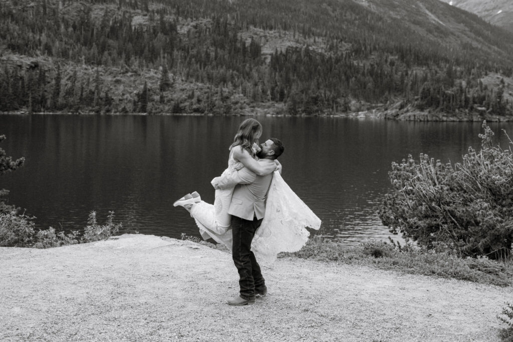 Black and white of groom spinning bride on lower part of Sun Point in Glacier National Park | Stacy Edwards Photography